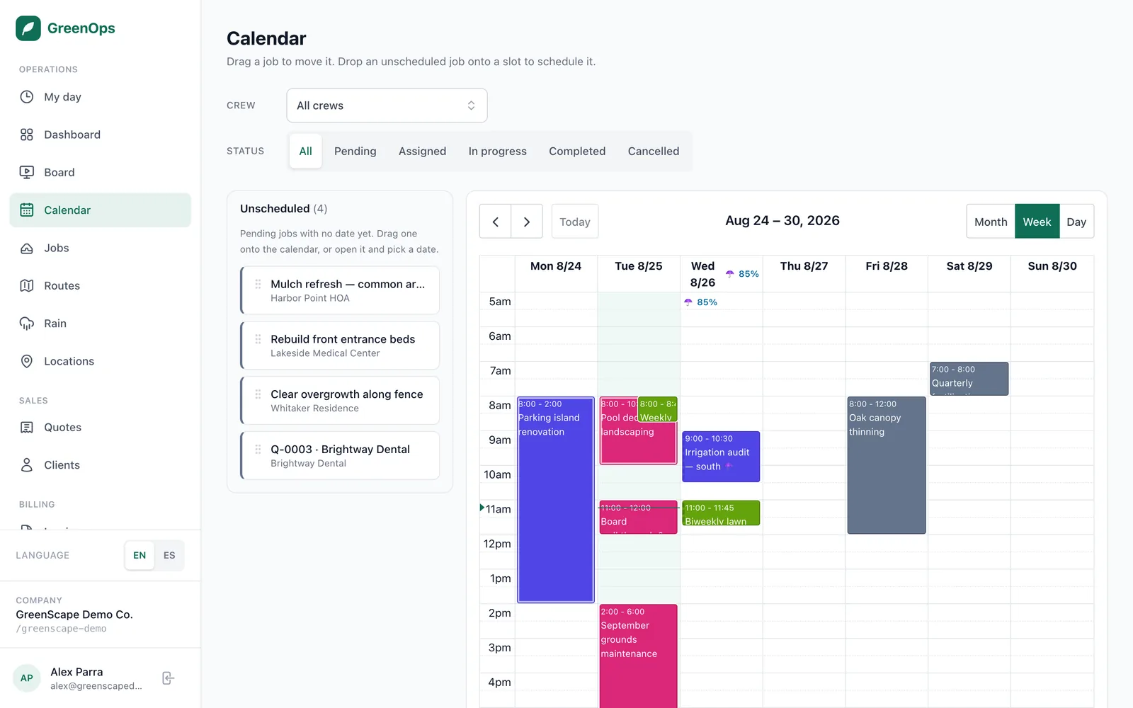 The GreenOps calendar in week view, with jobs colour-coded by crew and a panel of unscheduled work.